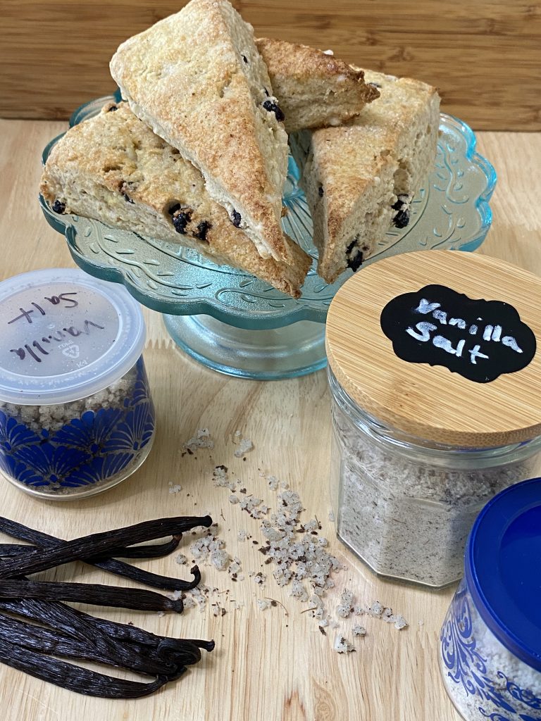 Blueberry-white chocolate chip gluten-free sourdough scones made with vanilla salt.  Vanilla salt in jars and some vanilla beans. 