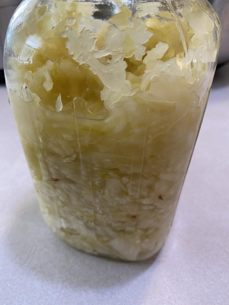Jar of finished sauerkraut with caraway seeds