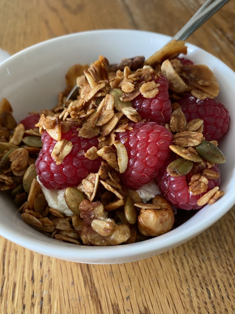 Gluten-free Granola over homemade yogurt and organic raspberries